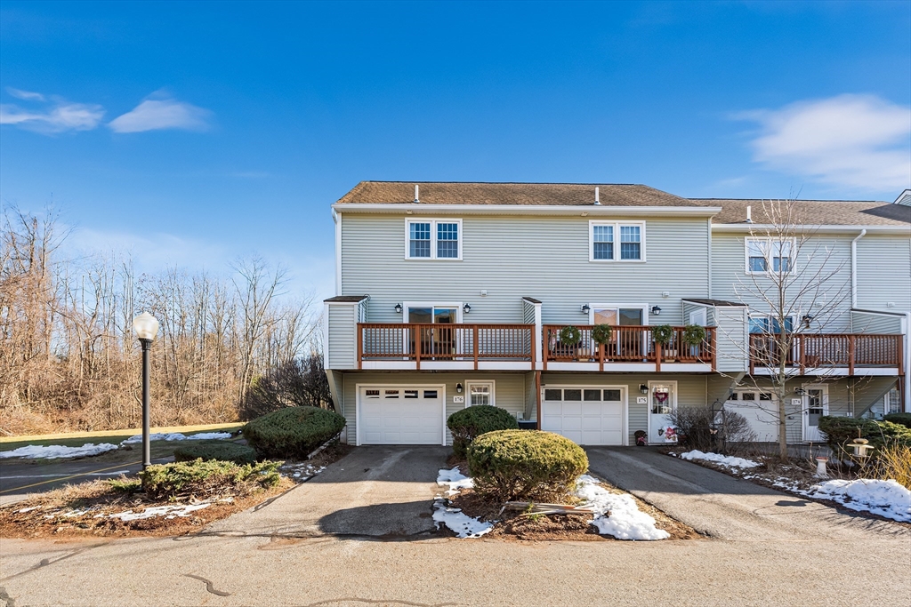 176 Patrick Road, Unit 176 Tewksbury, MA 01876 - Photo 36 of 42 a house view with a sitting space fire pit and outdoor space