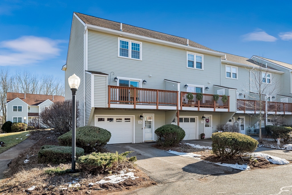 176 Patrick Road, Unit 176 Tewksbury, MA 01876 - Photo 37 of 42 a backyard of a house with barbeque oven table and chairs
