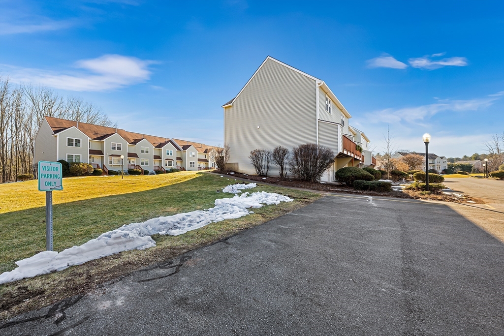 176 Patrick Road, Unit 176 Tewksbury, MA 01876 - Photo 40 of 42 a view of a house with a yard