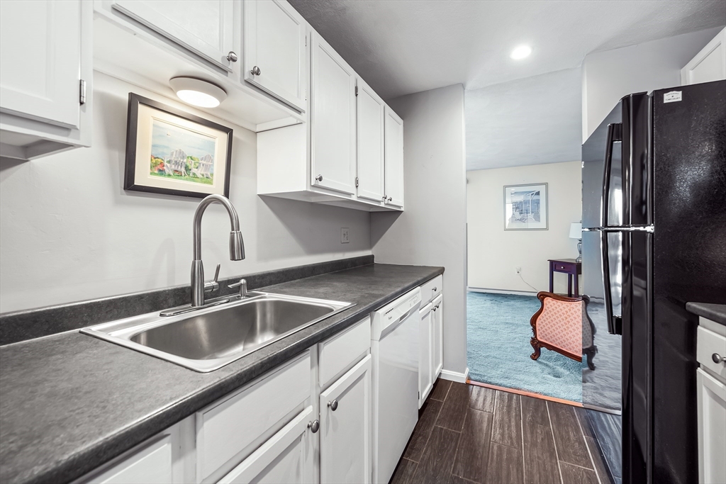 176 Patrick Road, Unit 176 Tewksbury, MA 01876 - Photo 6 of 42 a kitchen with stainless steel appliances granite countertop a sink refrigerator and cabinets