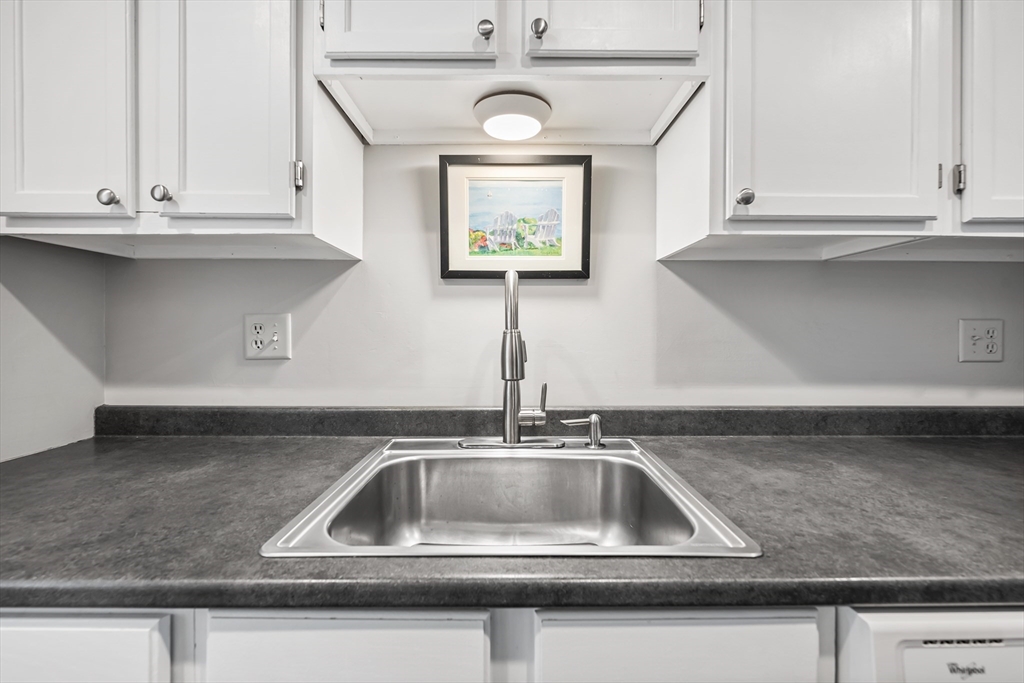 176 Patrick Road, Unit 176 Tewksbury, MA 01876 - Photo 7 of 42 a kitchen with a sink and cabinets