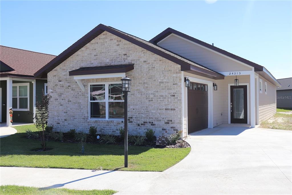 24313 Southwest 17th Lane Newberry, FL 32669 - Photo 2 of 15 a front view of a house with garden