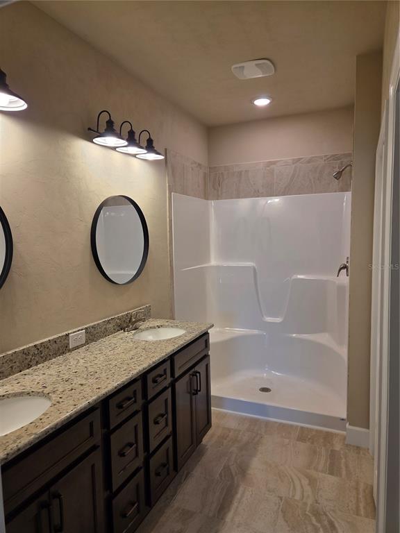 24313 Southwest 17th Lane Newberry, FL 32669 - Photo 7 of 15 a bathroom with a sink a mirror and a bathtub