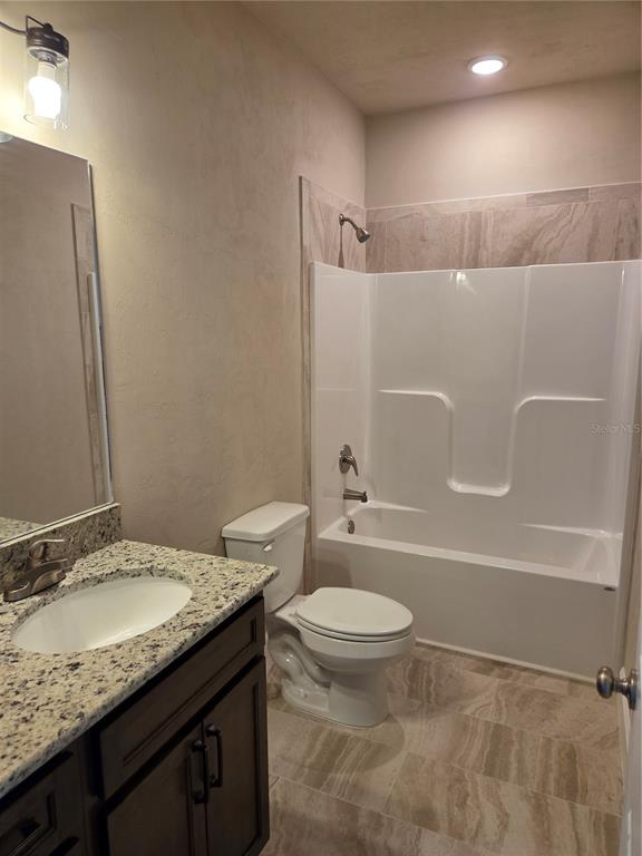 24313 Southwest 17th Lane Newberry, FL 32669 - Photo 9 of 15 a bathroom with a granite countertop sink toilet and shower