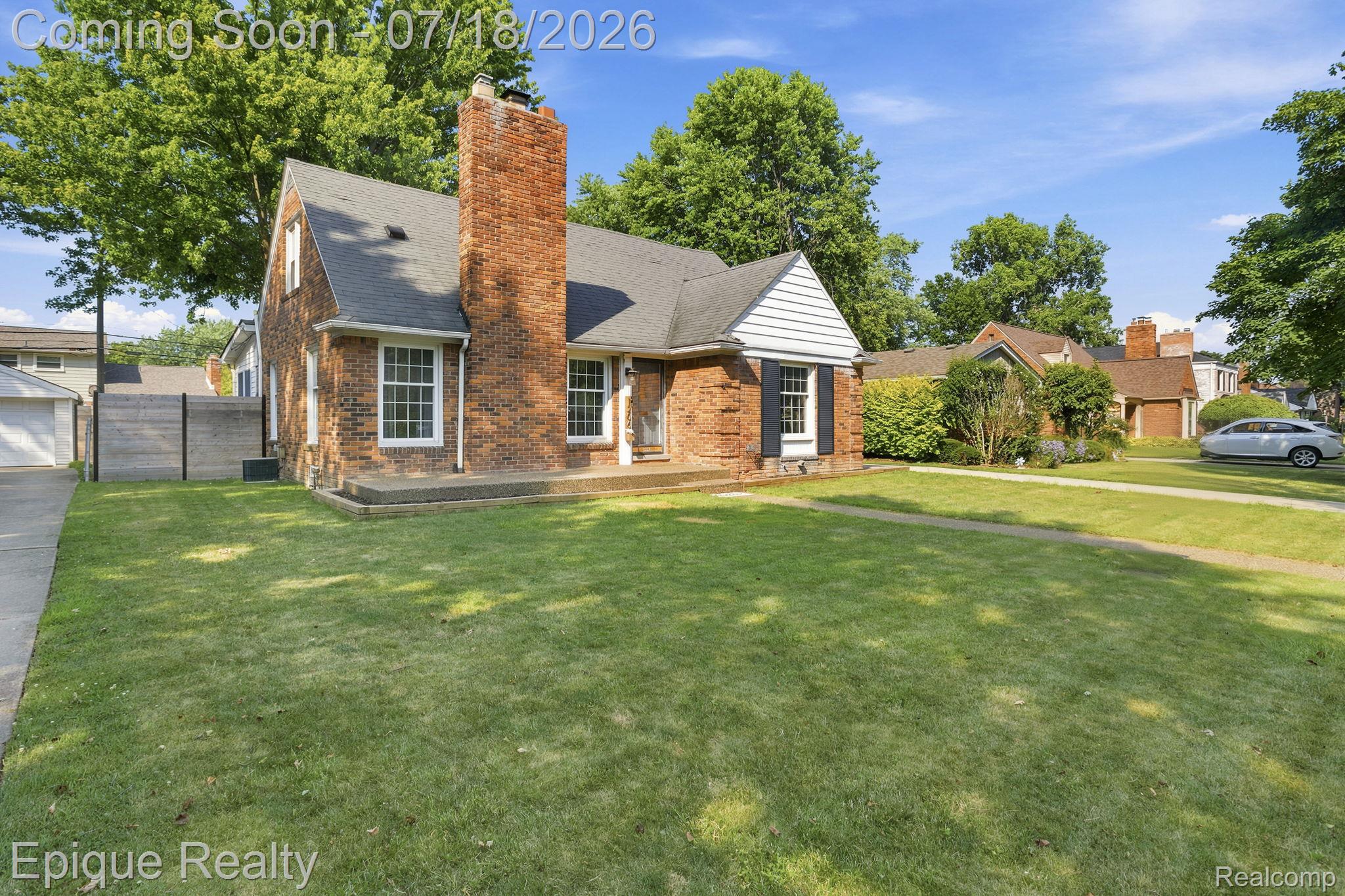 1206 Hawthorne Road Grosse Pointe, MI 48236 - Photo 27 of 28 Brick residence with a prominent chimney, dark shingle roof, and white-framed windows