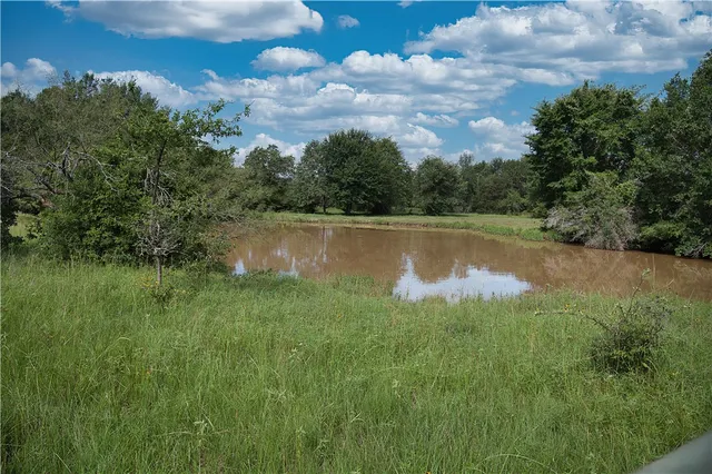 a view of a lake in between the of building and trees
