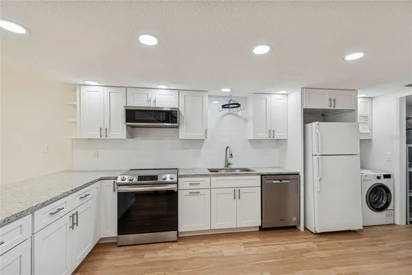 a view of an empty room with window and fire place