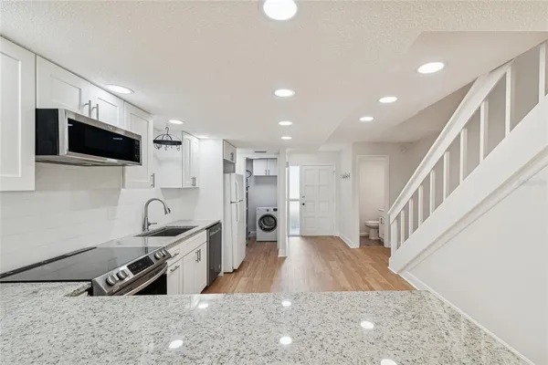 a an empty room with a fireplace and a window