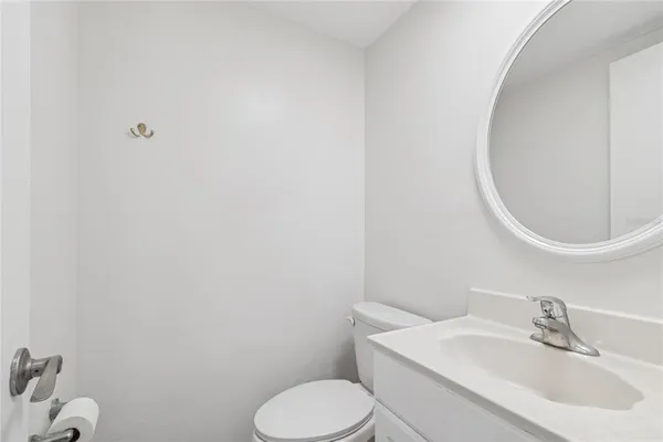a view of a kitchen with refrigerator and wooden floor