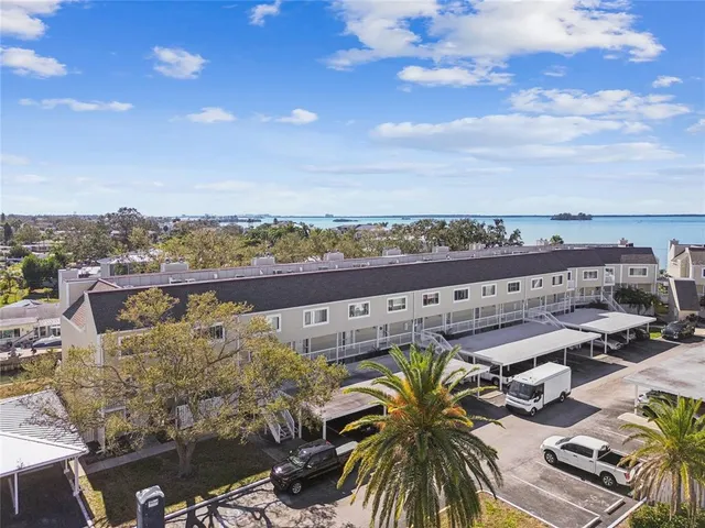 a view of a hallway with wooden floor and entryway