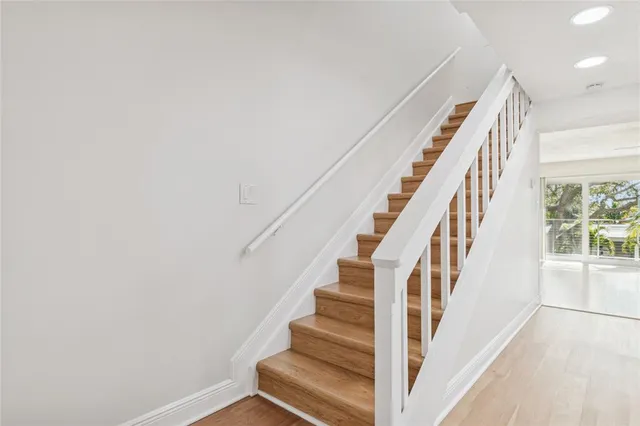 an empty room with fan and windows