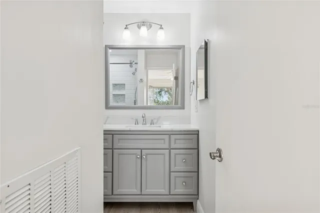an empty room with closet and a ceiling fan