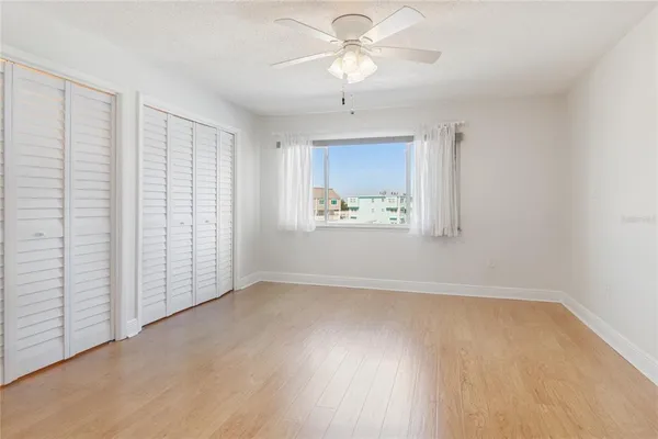 a view of house with large trees in front