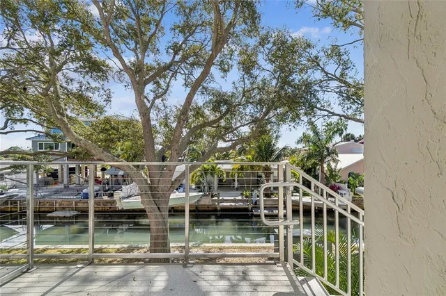an aerial view of residential houses with outdoor space and lake view