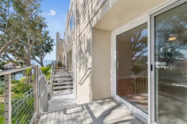 a view of an ocean with boats and trees in the background