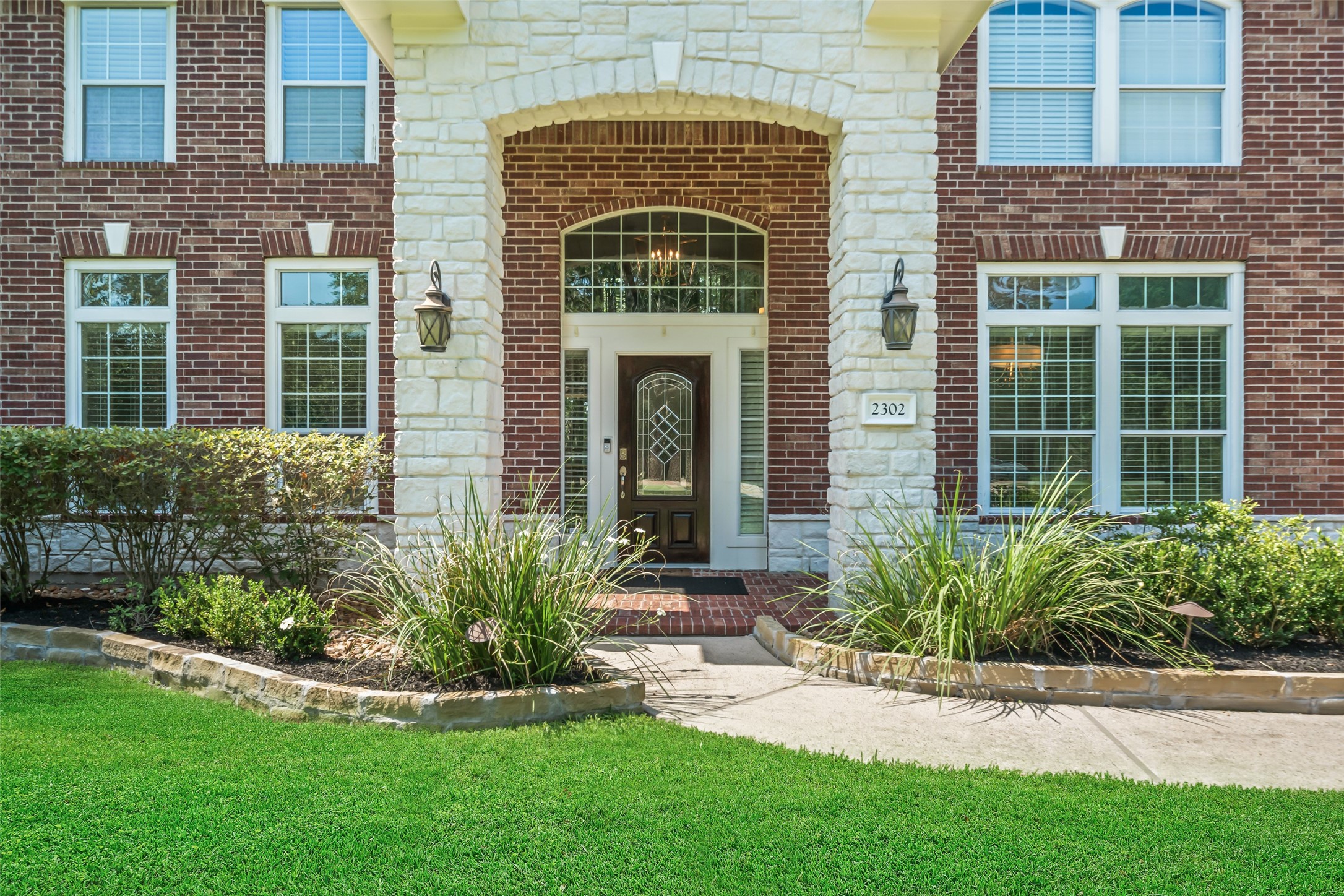 2302 Legends Shore Drive Spring, TX 77386 - Photo 5 of 48 Welcoming covered entry framed by stone accents and manicured landscaping.