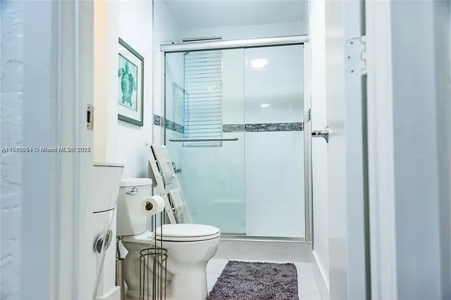 a bathroom with a toilet and a shower