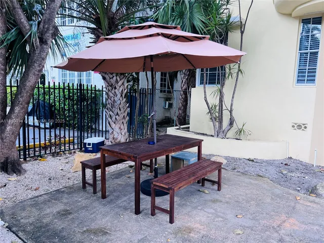 a backyard of a house with table and chairs