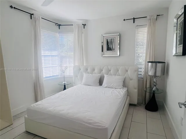 a large white bed in a white room