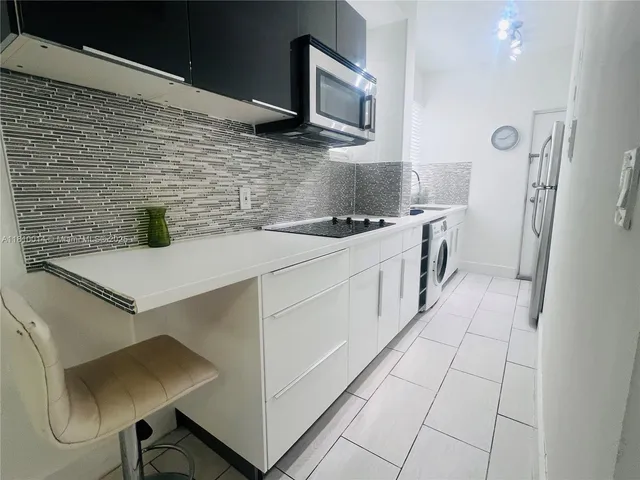 a kitchen with stainless steel appliances a sink stove and cabinets
