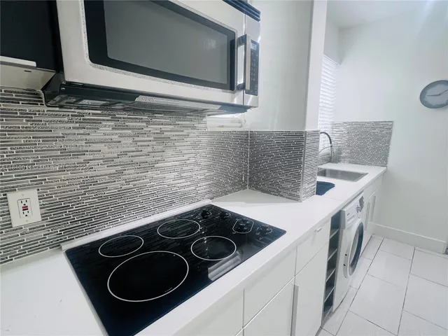 a kitchen with a sink stove and cabinets