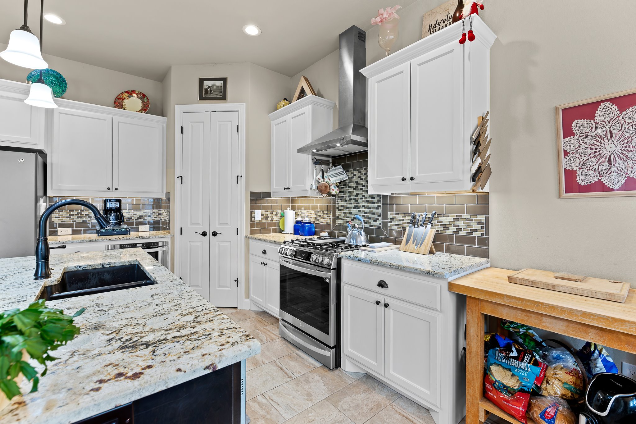 204 Venture Boulevard South Point Venture, TX 78645 - Photo 13 of 40 a kitchen with stainless steel appliances granite countertop a sink stove and refrigerator