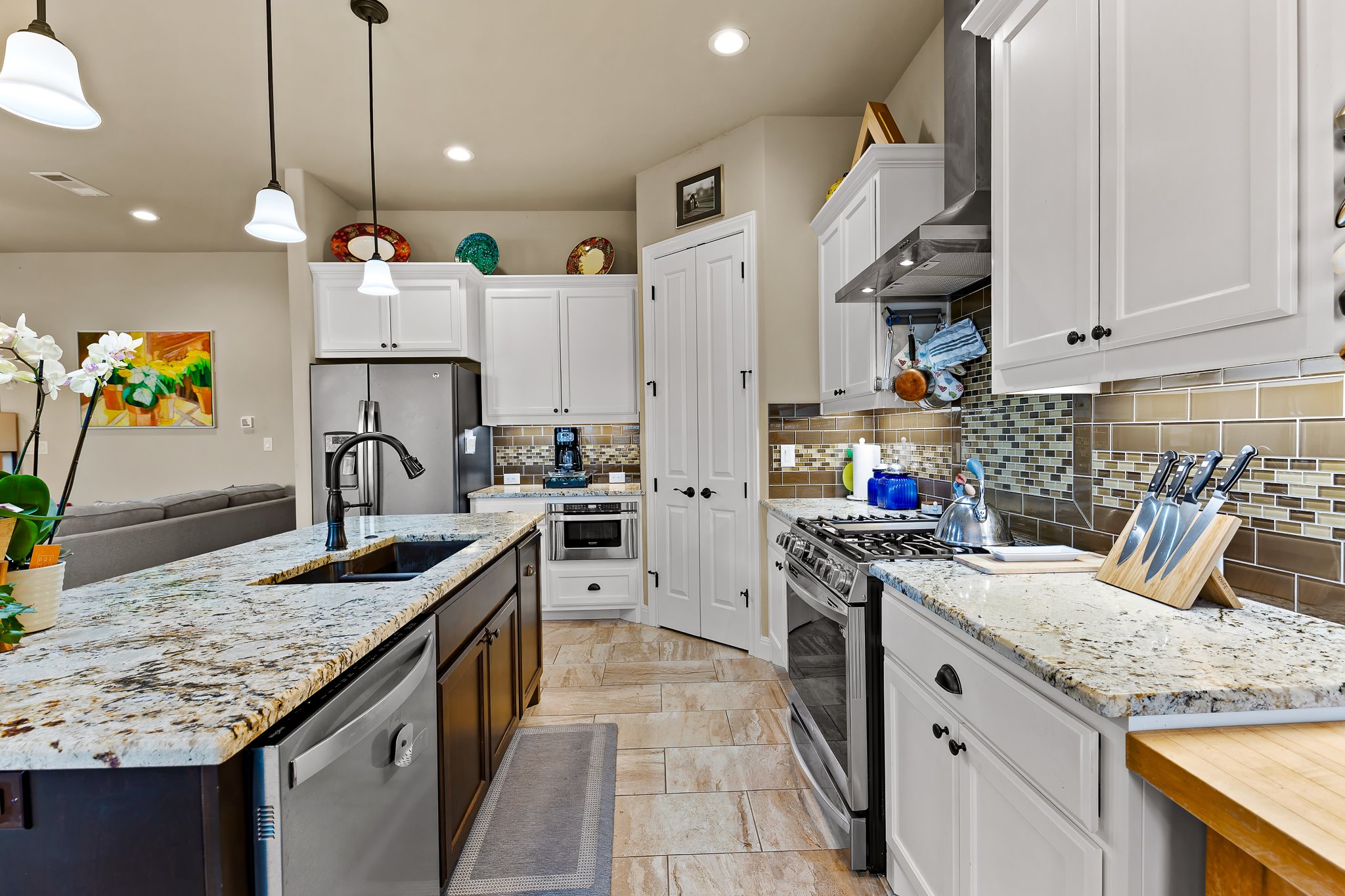 204 Venture Boulevard South Point Venture, TX 78645 - Photo 14 of 40 a kitchen with kitchen island granite countertop a sink a counter top space stove and cabinets