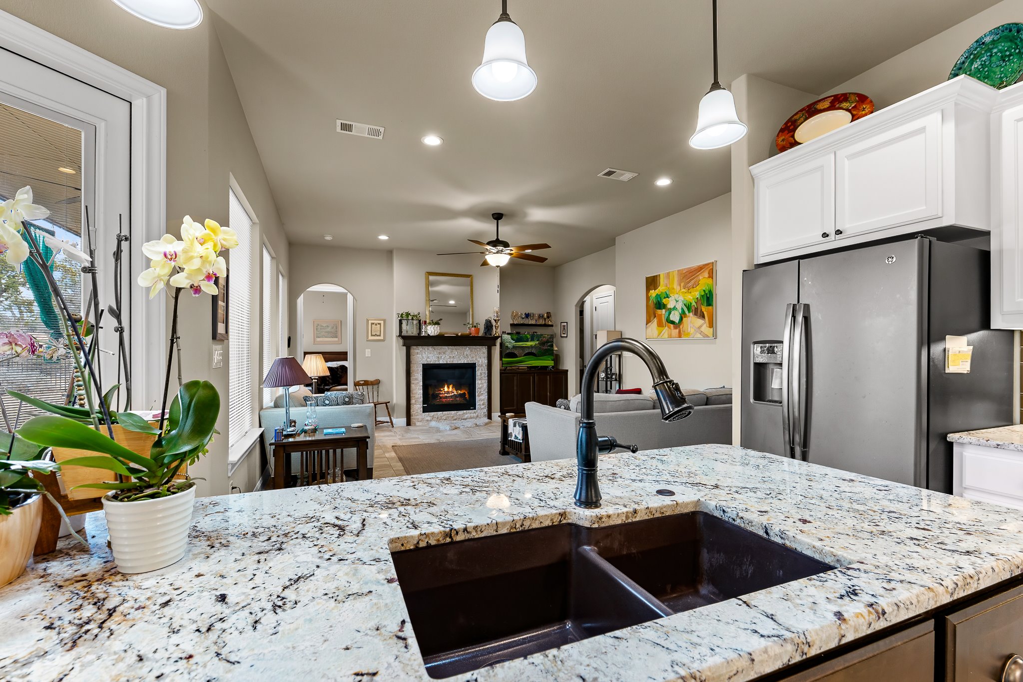 204 Venture Boulevard South Point Venture, TX 78645 - Photo 17 of 40 a kitchen with stainless steel appliances kitchen island granite countertop a sink a counter top space and living room view