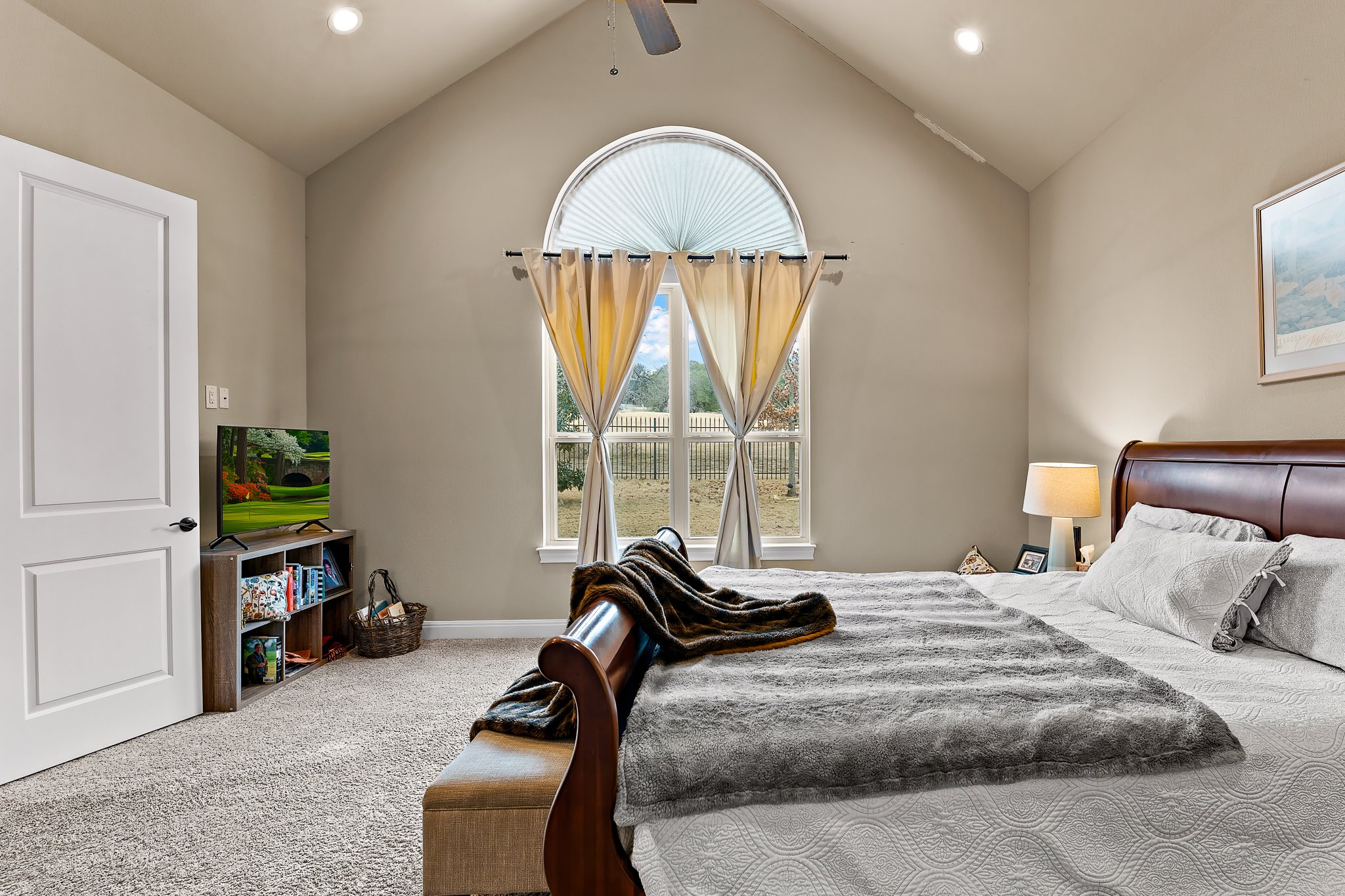 204 Venture Boulevard South Point Venture, TX 78645 - Photo 24 of 40 a bedroom with a bed and a chandelier
