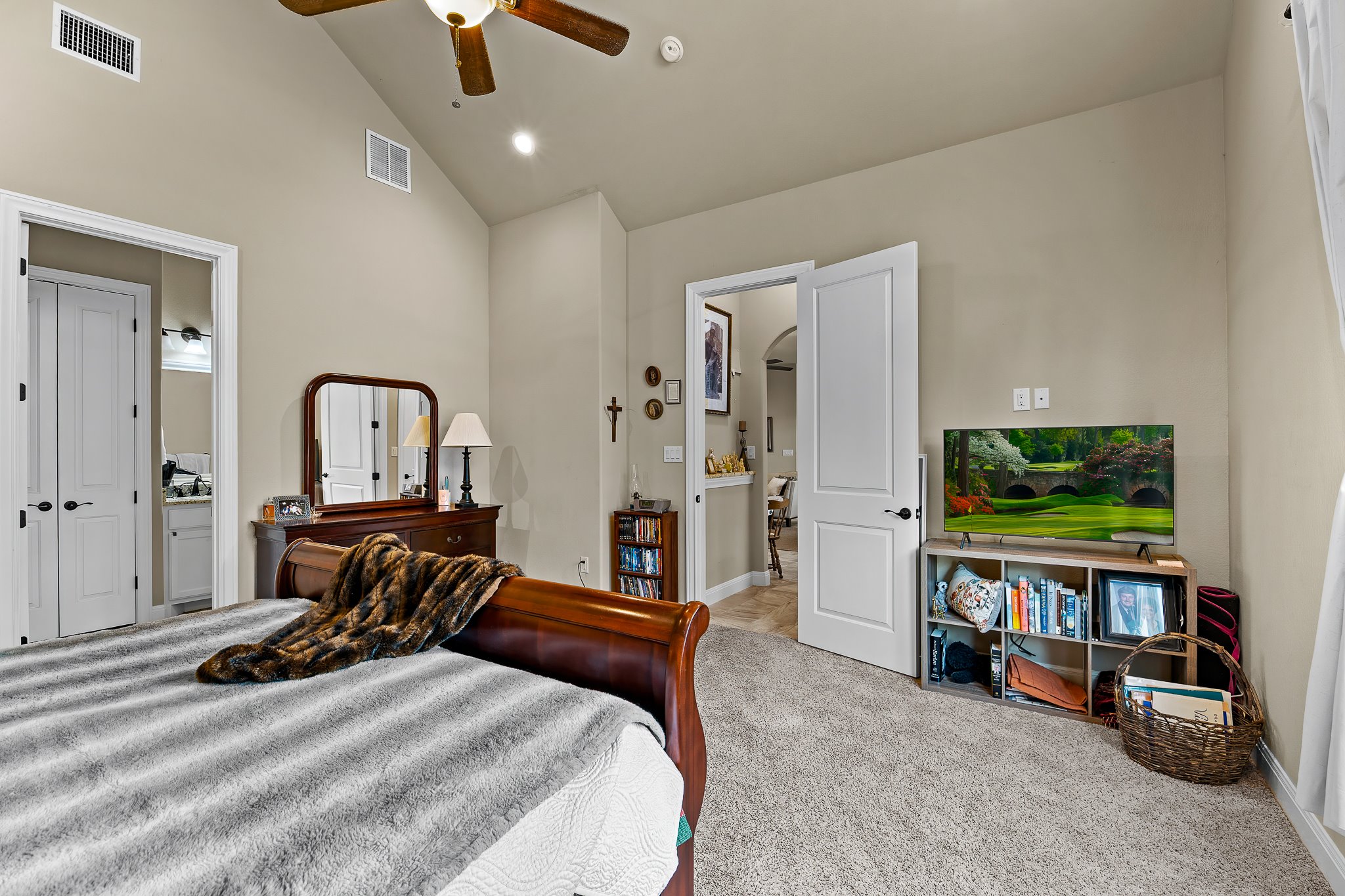 204 Venture Boulevard South Point Venture, TX 78645 - Photo 25 of 40 a bedroom with bed and a flat tv screen on dresser