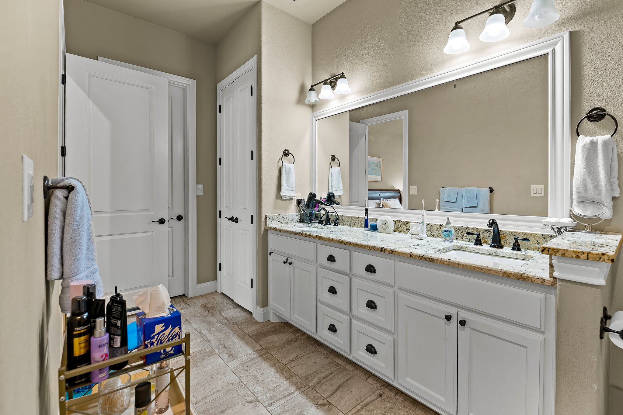 204 Venture Boulevard South Point Venture, TX 78645 - Photo 29 of 40 a bathroom with a double vanity sink a mirror and a shower