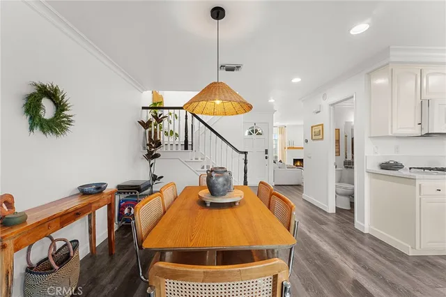 a kitchen with stainless steel appliances a stove a refrigerator and white cabinets