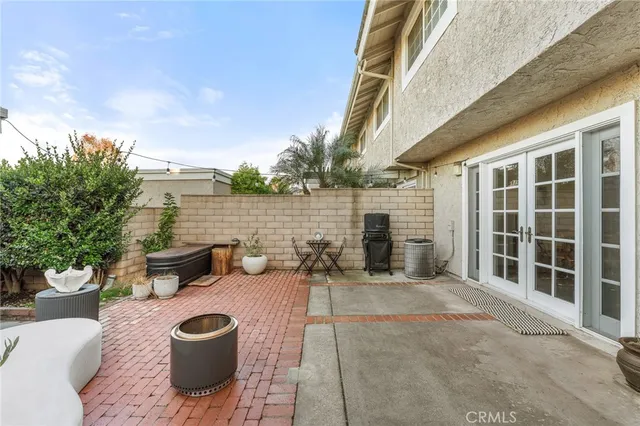 a view of a patio with couches chairs and potted plants