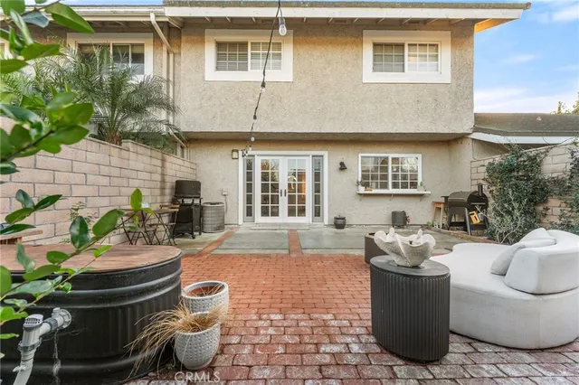 a view of a patio with couches chairs and potted plants