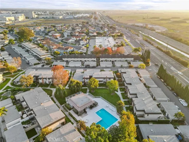 an aerial view of a house with a yard and fountain