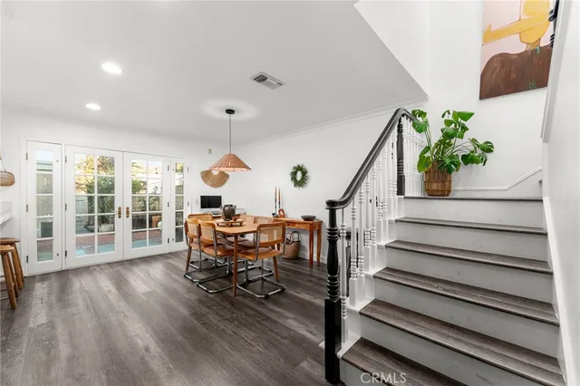 a dining room with furniture and wooden floor