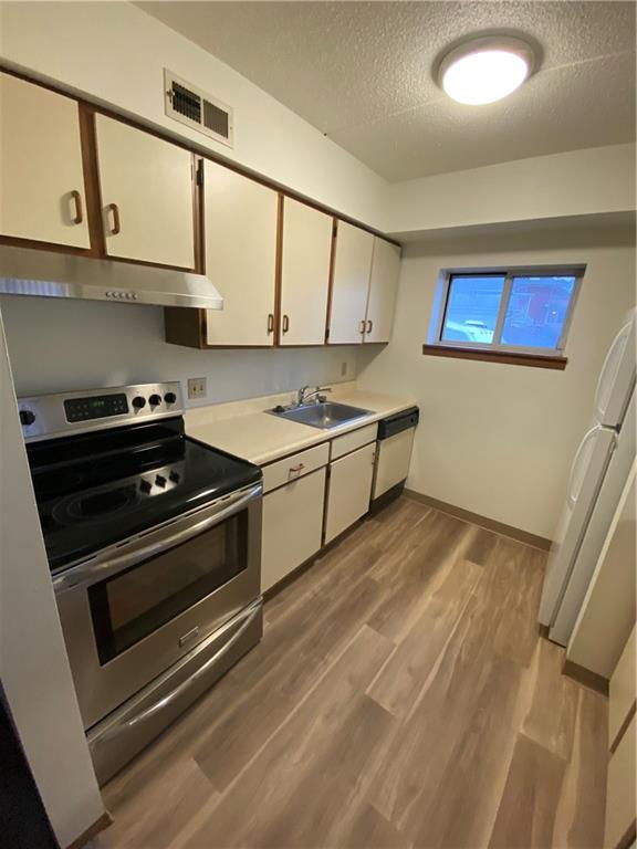 401-407 Freeport Road Pittsburgh, PA 15238 - Photo 19 of 25 a kitchen with stainless steel appliances a stove a microwave and sink