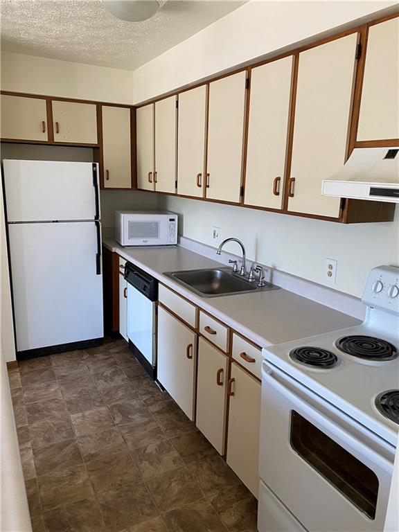 401-407 Freeport Road Pittsburgh, PA 15238 - Photo 25 of 25 a kitchen with a sink a stove and a refrigerator
