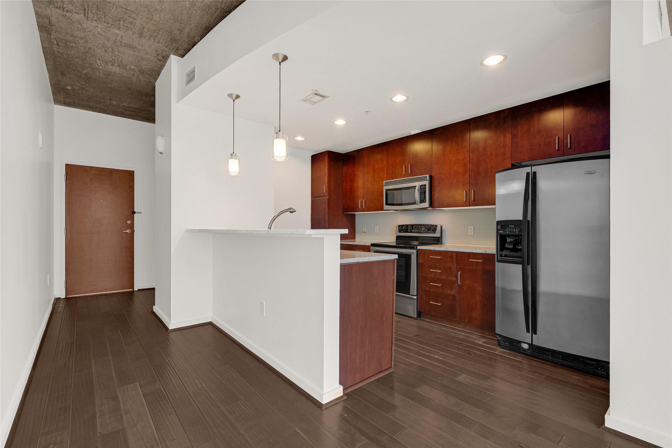 5925 Almeda Road, Unit 12308 Houston, TX 77004 - Photo 3 of 48 a kitchen with stainless steel appliances granite countertop a refrigerator a sink dishwasher and a oven with wooden floor