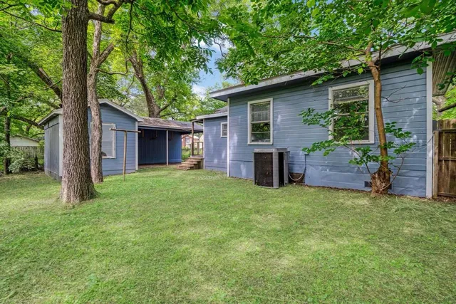 a view of a house with a yard and porch