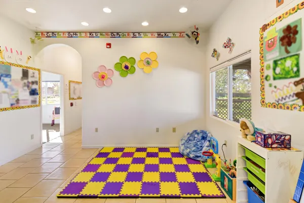 a bedroom with a bed and a painting on the wall