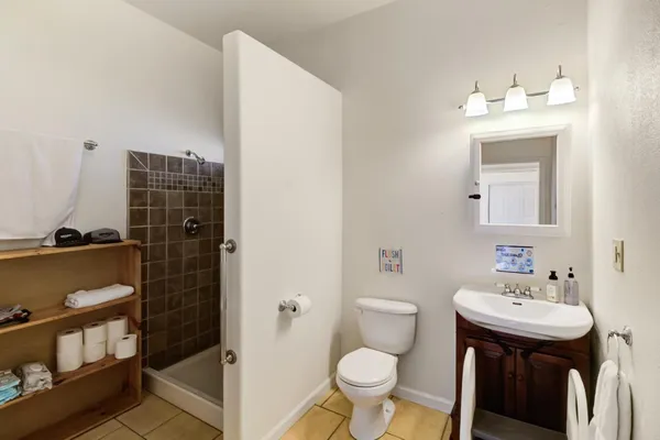 a bathroom with a sink toilet and shower