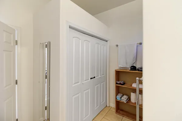 a view of a hallway with closet and a window