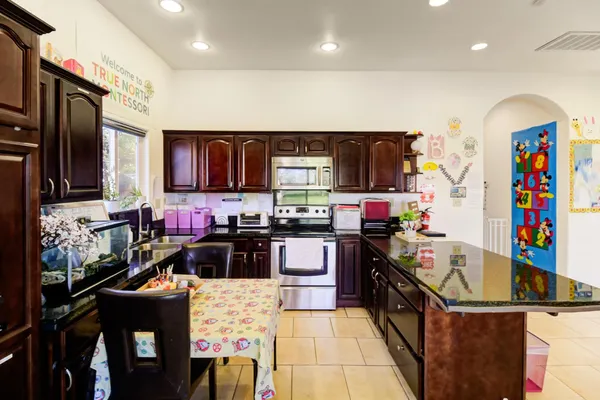 a kitchen with lots of appliances and wooden cabinets