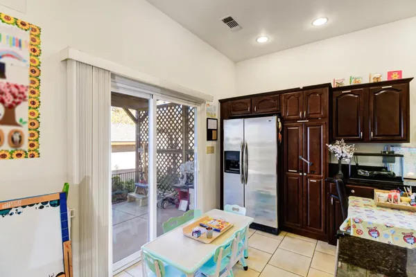 a kitchen with stainless steel appliances granite countertop a refrigerator and a sink