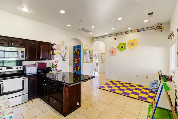 a kitchen with stainless steel appliances granite countertop a refrigerator and a stove top oven