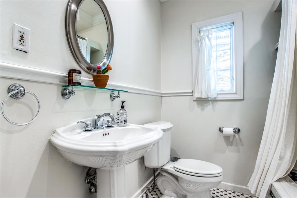 5506 Ridgedale Avenue Dallas, TX 75206 - Photo 14 of 16 a bathroom with a sink a toilet and a mirror