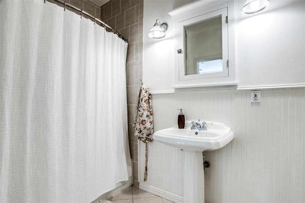 5506 Ridgedale Avenue Dallas, TX 75206 - Photo 15 of 16 a bathroom with a sink a mirror and a sink