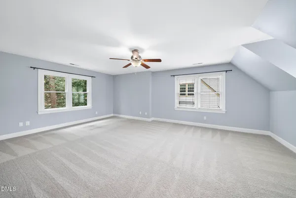 a living room with furniture and a ceiling fan