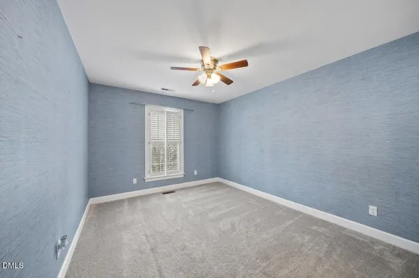 an empty room with wooden floor
